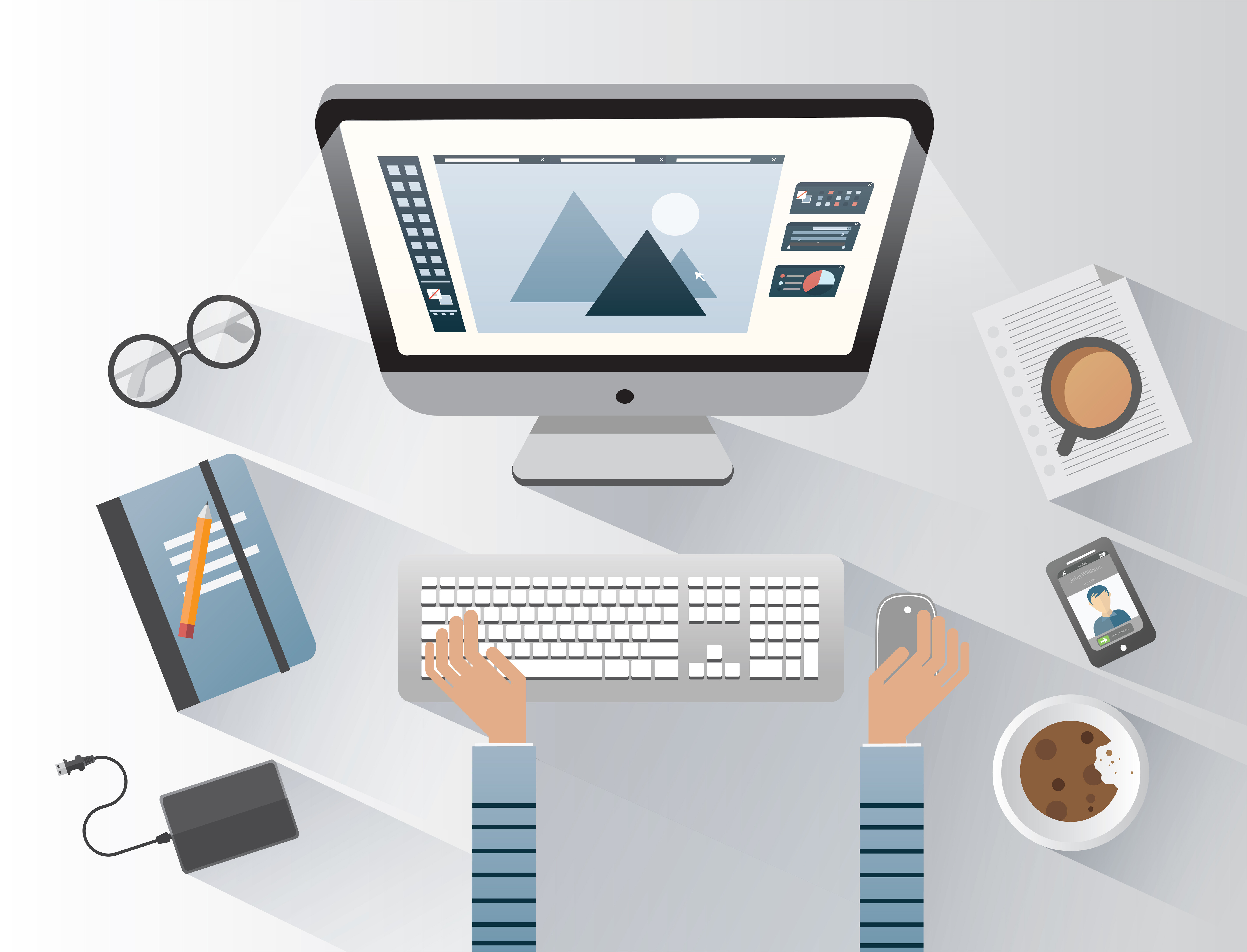 Modern desk setup with computer design software open, person working with keyboard and mouse