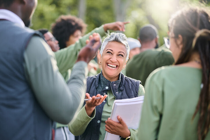 Cheerful woman engaging in a lively conversation during a community event.