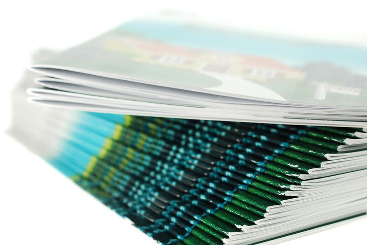 Close-up of a neatly stacked pile of colorful booklets.