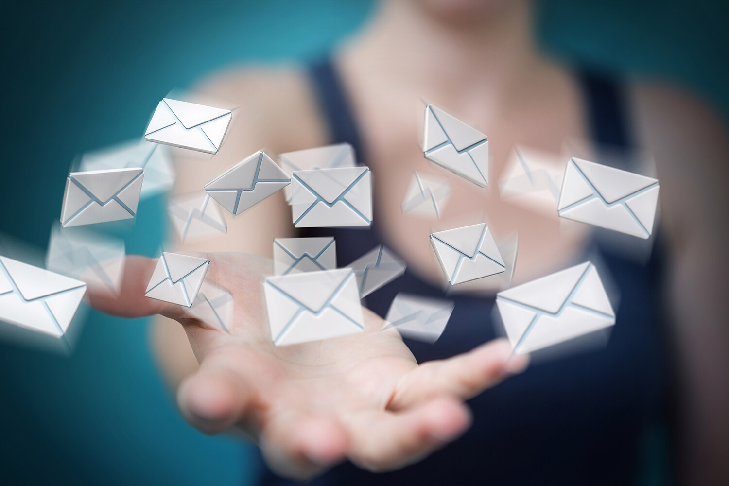 Person holding out hand with floating digital email icons