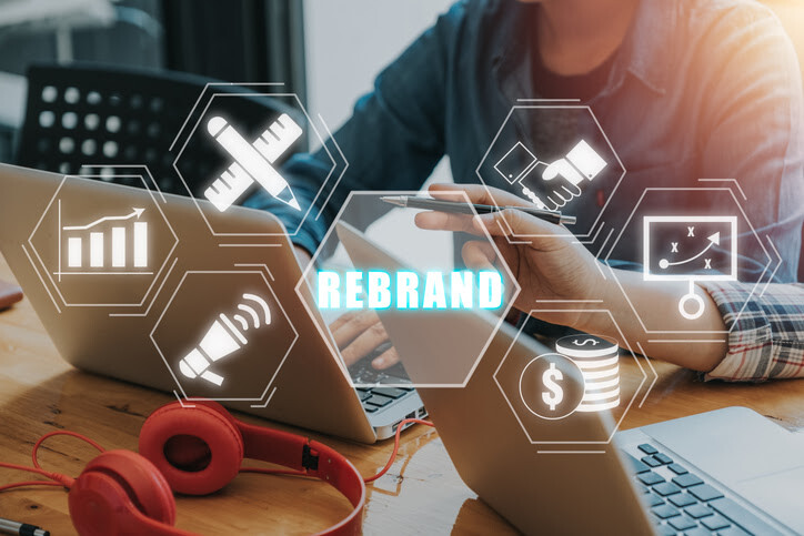 Concept of rebranding with laptop workspace and digital business-related graphics.