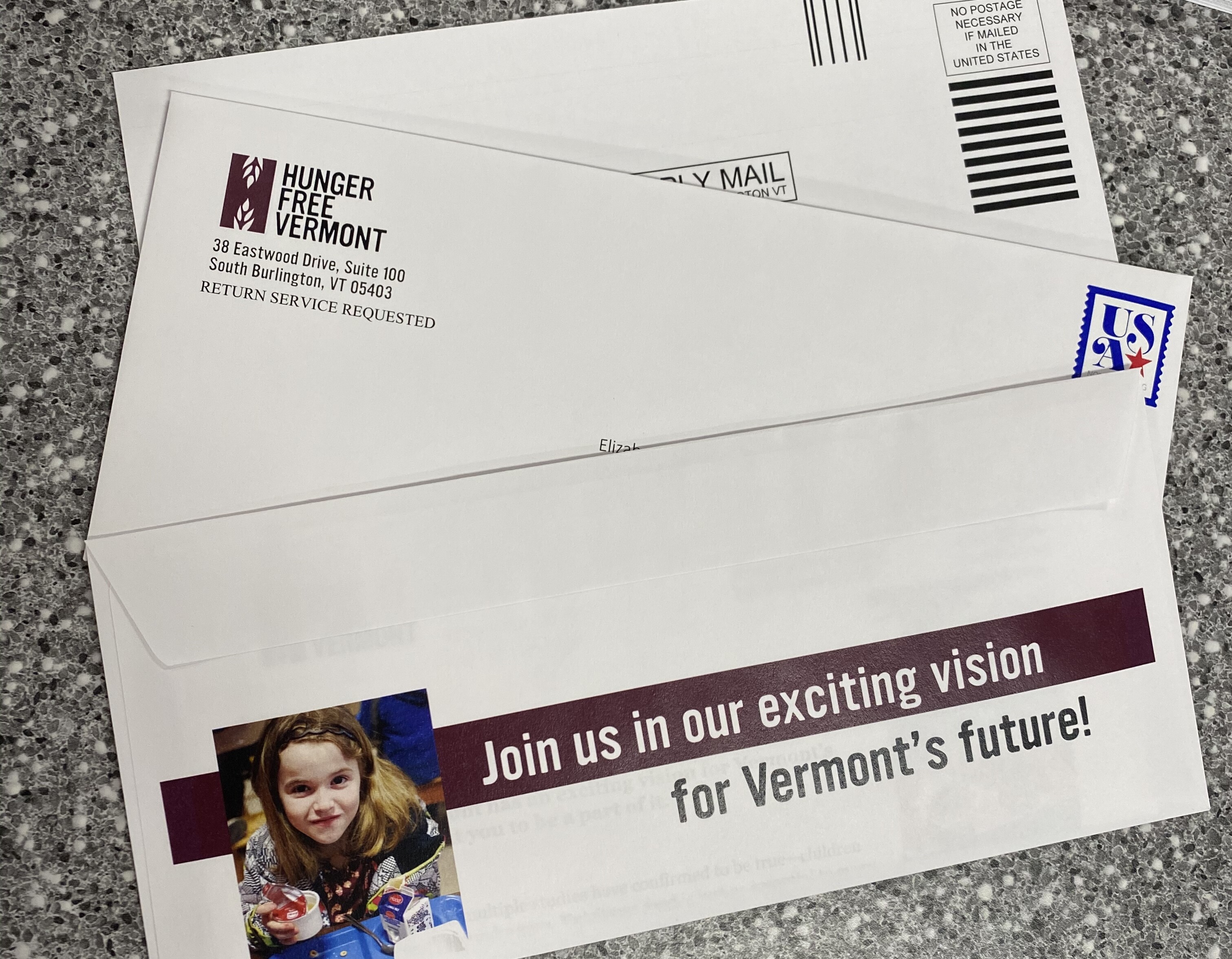 Hunger Free Vermont envelope with a child’s image and call to action for Vermont’s future.