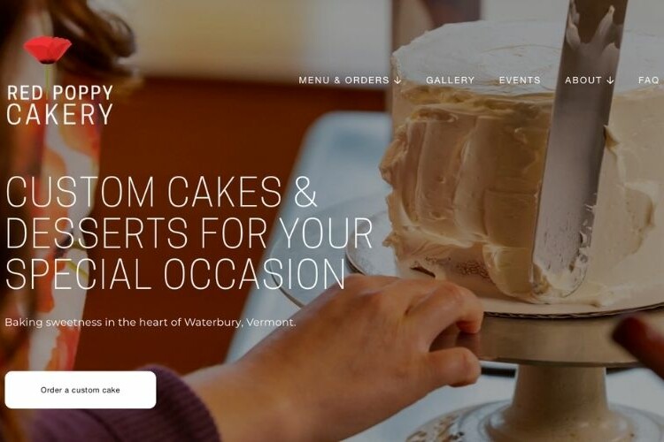 Website homepage featuring close-up of hands smoothing white buttercream onto a custom cake using an offset spatula.