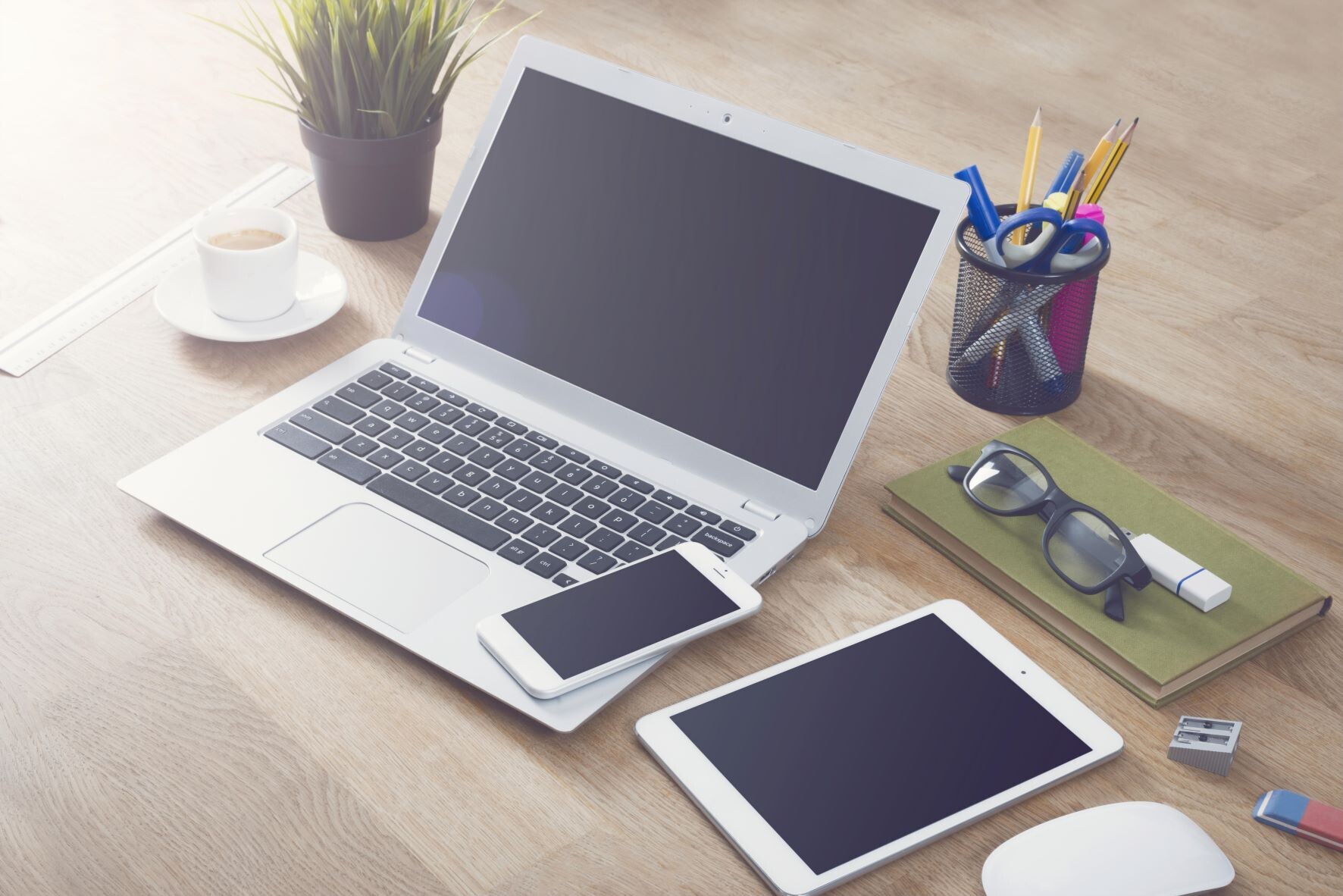 Desk setup with laptop, tablet, smartphone for responsive website design