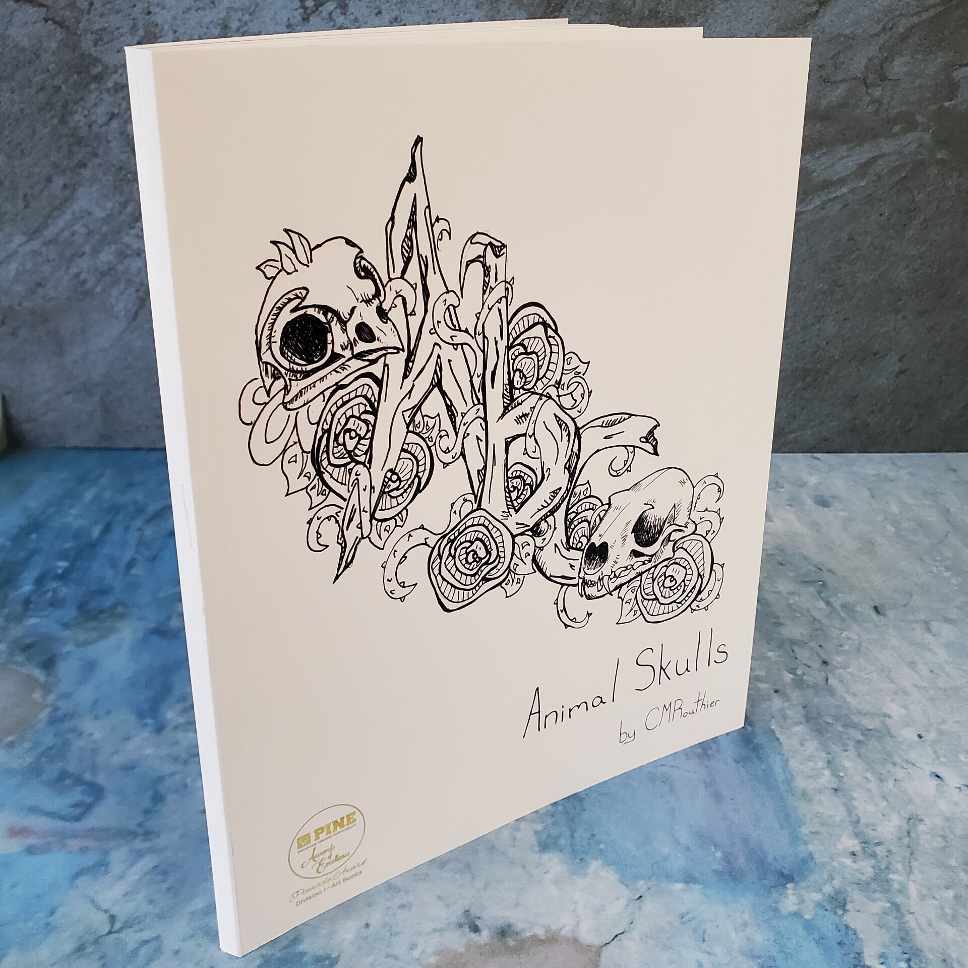 PINE Awards of Excellence - Pinnacle Award Winning perfect bound book - Animal Skulls by CMRouthier.